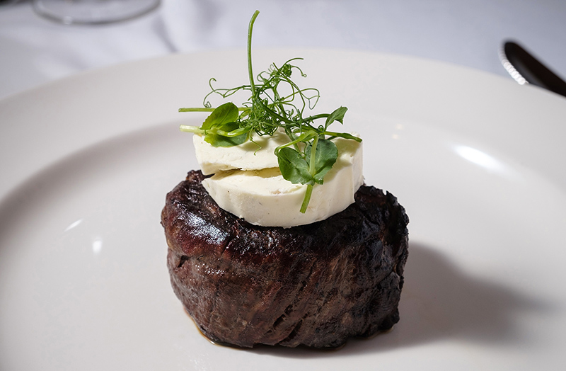 Picture of beef garnished with delicious ingredients at Bass Street Chop House